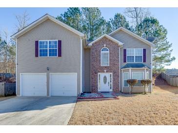 Two-story house with brick and siding, two-car garage, and manicured lawn at 4089 Palm Dr, Snellville, GA 30039