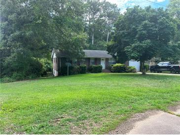 Brick ranch home with a spacious yard and driveway at 1473 Brownleaf Dr, Jonesboro, GA 30236