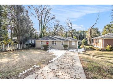 Ranch style home with a stone pathway and mature trees at 2077 Rosewood Rd, Decatur, GA 30032