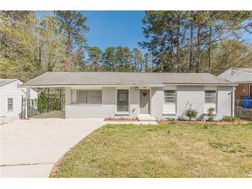 Charming single-story home with a freshly painted gray brick exterior, carport, and well-manicured front yard at 2649 Santa Barbara Nw Dr, Atlanta, GA 30318