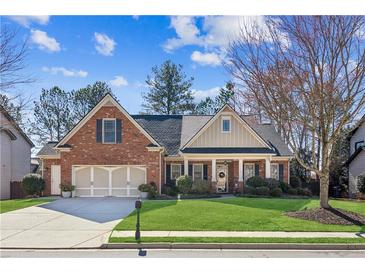 Charming brick home featuring a well-manicured lawn and a two-car garage, offering curb appeal and convenience at 535 Cape Ivey Dr, Dacula, GA 30019