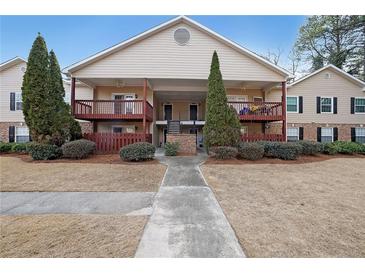 Two-story condo building with balconies and landscaped grounds at 1707 Brighton Point, Sandy Springs, GA 30328