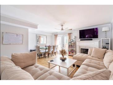 Spacious living room with sectional sofa, fireplace, and dining area at 1801 Cumberland Valley Pl, Atlanta, GA 30080