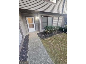 Inviting townhouse entry with walkway, landscaping, and a private entrance at 2753 Whitewater Ct, Austell, GA 30106