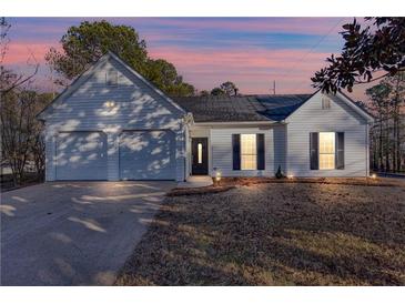 Charming single-story home with white siding, attached garage, and well-manicured lawn at 4100 Chanticleer Nw Dr, Kennesaw, GA 30152