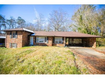 Brick ranch house with carport, situated on a spacious lot at 1351 Harbin Rd, Atlanta, GA 30311