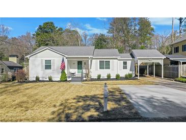 Charming white house with well-manicured lawn and driveway at 390 Cascade Nw Dr, Marietta, GA 30064