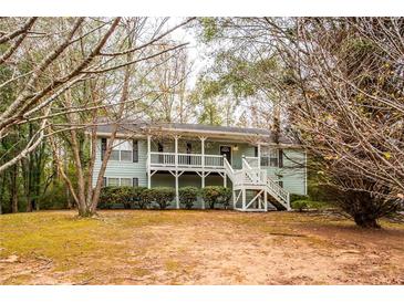 Ranch style home with a wrap-around porch and large yard at 476 Cody Ln, Douglasville, GA 30134