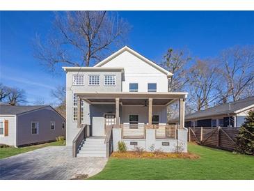 Two-story modern home with gray brick, front porch, and landscaped lawn at 1565 Pineview Sw Ter, Atlanta, GA 30311