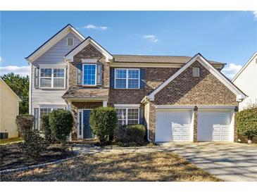 Brick two-story house with two-car garage and landscaped yard at 960 Maple Leaf Dr, Mcdonough, GA 30253