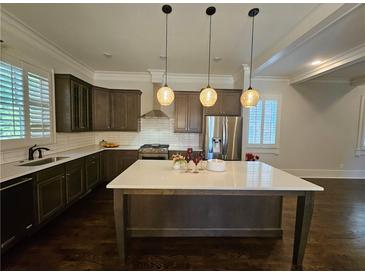 Spacious kitchen with island, stainless steel appliances, and dark wood cabinets at 5981 Brundage Ln, Norcross, GA 30071