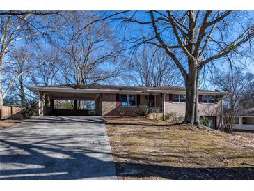Brick ranch house with carport and mature trees at 850 Briarwood Trl, Douglasville, GA 30134