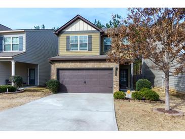 Two-story house with brown garage door and landscaped yard at 4505 Ravenwood Dr, Union City, GA 30291