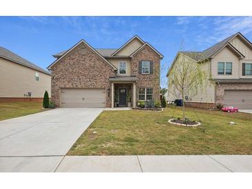 Brick two-story house with a gray door and attached garage at 824 Lakehaven Ln, Loganville, GA 30052
