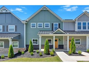 Two-story townhome with inviting front porch and landscaping at 704 Fairgate Rd, Marietta, GA 30064