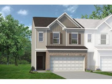 Two-story townhome with brick and siding exterior, two-car garage, and landscaping at 213 Bastian Dr # 6, Villa Rica, GA 30180