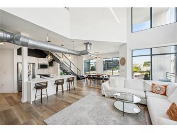 Open living area with high ceilings, hardwood floors, and ample natural light at 260 18Th Nw St # 10311, Atlanta, GA 30363