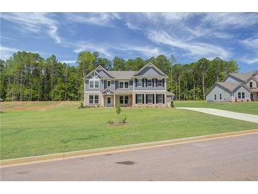 Two-story home with gray siding, brick accents, and a landscaped lawn at 62 Homesite Cooper W Cv, Fayetteville, GA 30215