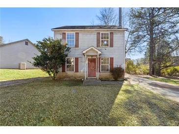 Two-story house with red door and small yard at 9119 Fairway Ct, Riverdale, GA 30274