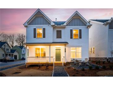 Two-story home with a charming front porch and landscaped yard at 907 E Green Ln, Clarkston, GA 30021