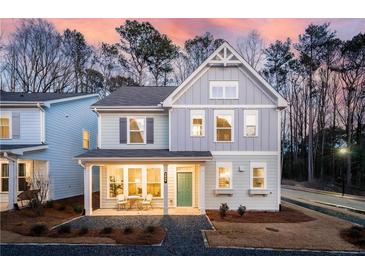 Two-story home with gray siding, front porch, and landscaping at 3827 Cottage Cir, Tucker, GA 30021