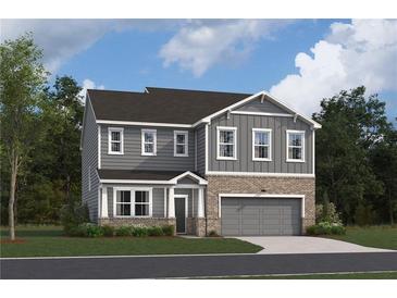 Two-story house with gray siding, brick accents, and a two-car garage at 319 Willam Gossett Dr, Canton, GA 30114