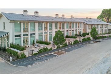 Beautiful townhomes featuring a painted brick facade, large windows, and meticulous landscaping at 190 Rolison Way, Fayetteville, GA 30214