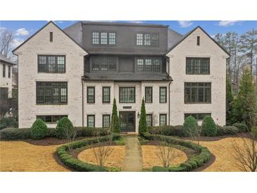 Beautiful three story home featuring traditional architecture, tidy landscaping, and a symmetrical design at 6442 Canopy Dr, Sandy Springs, GA 30328