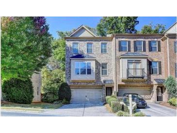 Brick front townhouse with 2-car garage and balcony at 2790 Laurel Valley Trl, Buford, GA 30519