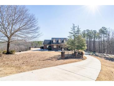 Brick home with large driveway and landscaped yard at 1150 Brushy Mountain Rd, Rockmart, GA 30153