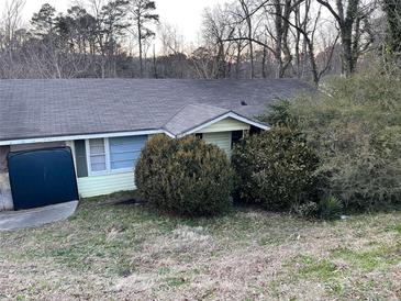 Ranch style home with mature landscaping and a large yard at 5906 Oakdale Rd, Mableton, GA 30126