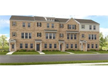 Three-story townhome community with brick exteriors and landscaped lawns at 241 Lytham Se Dr, Mableton, GA 30126