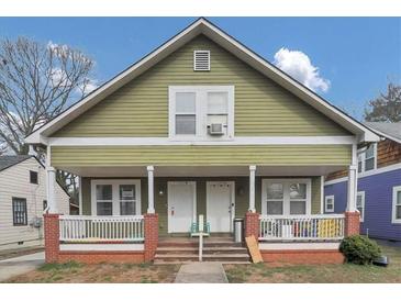 Charming two-story duplex with a green exterior, front porch, and brick accents at 1177 Arlington Ave, Atlanta, GA 30310