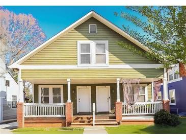 Charming duplex with a green exterior, two entrances, and a brick porch at 1177 Arlington Ave, Atlanta, GA 30310