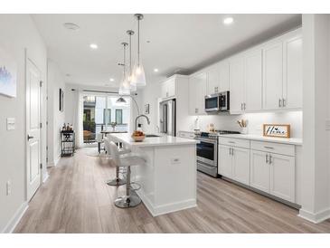 Modern kitchen with white cabinets, island, and stainless steel appliances at 396 Pratt Se Dr # 1932, Atlanta, GA 30315