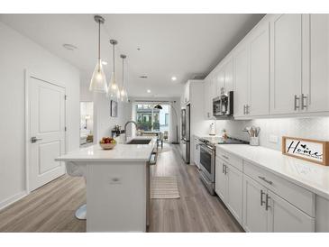 Modern kitchen with white cabinets, stainless steel appliances, and island at 396 Pratt Se Dr # 1932, Atlanta, GA 30315