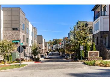 Street view showcasing modern townhomes with brick and siding exteriors in a vibrant community setting at 396 Pratt Se Dr # 1932, Atlanta, GA 30315