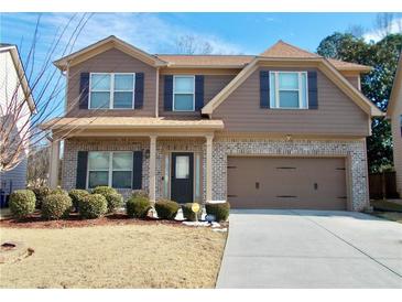 Two-story house with brick and siding, two-car garage, and landscaping at 2338 Newbury Oaks Dr, Lawrenceville, GA 30044