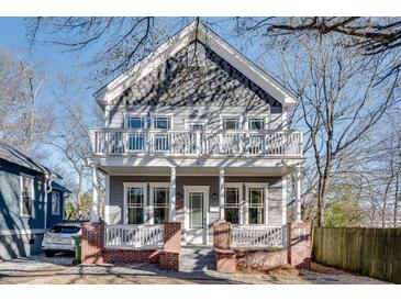 Two-story gray house with white trim, balconies, and brick accents at 249 Josephine Ne St, Atlanta, GA 30307