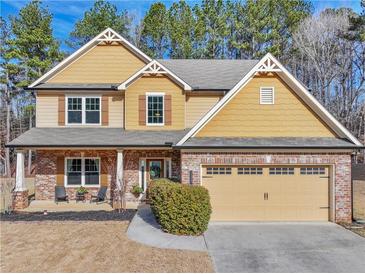 Two-story house with a brick and siding exterior, a large garage, and landscaping at 1227 Clear Stream Rdg, Auburn, GA 30011