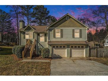 Two-story house with two-car garage and landscaped yard at 1215 Mountain Springs Nw Dr, Kennesaw, GA 30144