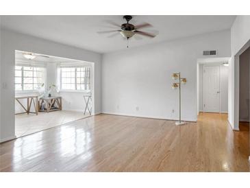 Bright living room with hardwood floors and access to sunroom at 1468 Briarwood Ne Rd # 1307, Brookhaven, GA 30319