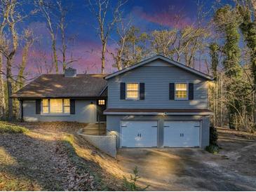 Gray house with a two-car garage and landscaping at 2545 Kingswood Dr, Marietta, GA 30066