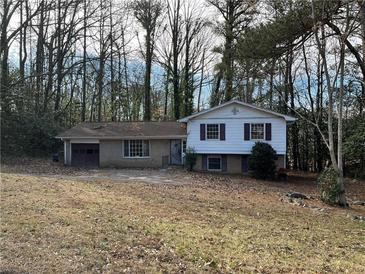 Ranch house with attached garage and mature trees at 905 Nw Magna Carta Dr, Atlanta, GA 30318