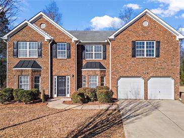 Brick two-story house with a two-car garage and manicured lawn at 221 Cutbank Sw Ct, Atlanta, GA 30331