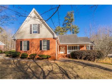 Brick and shingle two-story house with a large yard at 2216 Mcdaniel Mill Sw Rd, Conyers, GA 30094