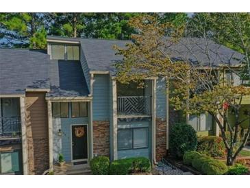 Charming townhome with a gray roof and stone accents at 64 Goldrush Cir, Atlanta, GA 30328