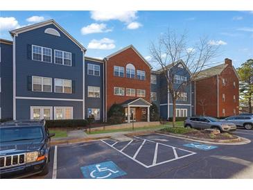 Brick and blue building exterior with parking lot and landscaping at 3302 Dogwood Dr # 123S, Atlanta, GA 30354