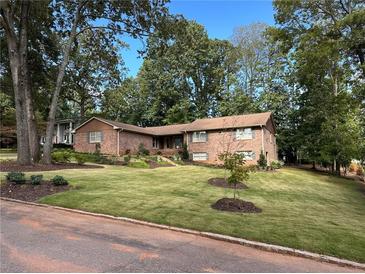 Brick ranch home with landscaped yard at 747 Dogwood Cir, Norcross, GA 30071