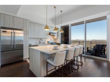 Modern kitchen with stainless steel appliances and breakfast bar at 1820 Peachtree Nw St # 1005, Atlanta, GA 30309